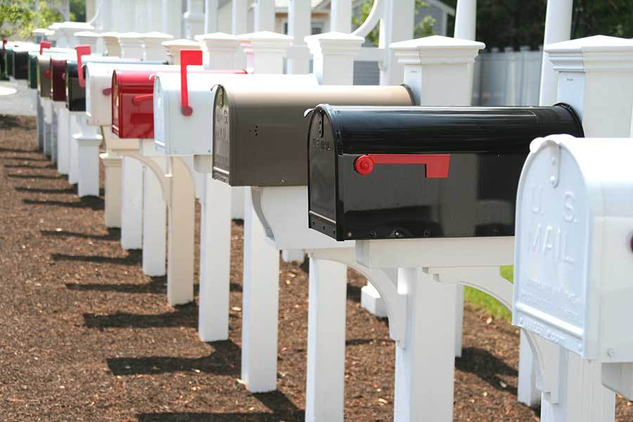A row of mailboxes out front of a homeowner association community to represent the different homes in an HOA community.
